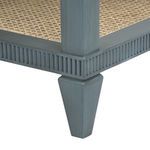 Close-up of fluted apron and one tapered wooden leg finished in lacquered blue