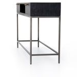 Side angle focusing on the metal frame structure supporting the black wood console top