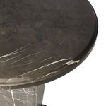 Close-up of round tabletop edge showing polished marble finish with white streak detail