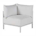Rear-side angle of the outdoor corner sofa highlighting the thin legs and cushion edges in chalk color