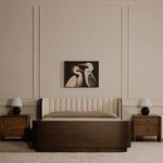 Two Tuve table lamps on matching wooden bedside tables in a beige bedroom with artwork above bed