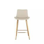 Front view highlighting the full stool silhouette with gold legs and white seat