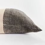 Close-up on Jules Pillow corner highlighting dark gray woven texture and stitching