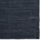 close-up showing plush dark blue ribbed surface texture of rug edge