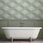 Fractal Sage wallpaper applied on wall behind clawfoot bathtub in muted sage bathroom setting.