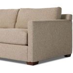 Side angle of right arm and back cushion highlighting fabric texture and shape