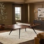 Ping pong table in styled game room setting with warm lighting and decorative accents