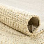 Rolled edge detail showing the thickness and tight weave of the handwoven rug fibers