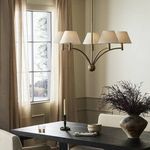 Linus Chandelier lit in warmer light tone, angled showing curvature of arms and shades