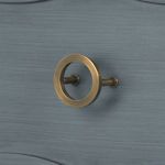 Brass ring drawer pull detail on foggy horizon finished drawer front with carved edging