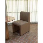 Sally Dining Chair styled next to round marble and wood pedestal table on terracotta floor tiles
