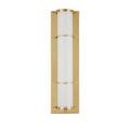 Straight-on view showing polished brass frame and milky glass tube of Blaine sconce with soft warm light