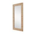 Close-up focus on layered tile surface and brass inlay on mirror frame with subtle texture