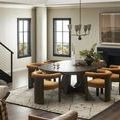 Spacious dining room featuring six rust upholstered Buxton Dining Chairs arranged around large round table
