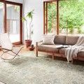 Skye Natural Sage rug styled in a bright living room under a sofa near large windows with natural light