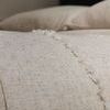 Macro view highlighting fine frayed trim and woven texture of natural bamboo linen sheets