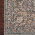 Edge detail of Rosemarie rug showing tightly finished binding and pattern near border on wood floor