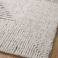 Close view of rug’s textured pattern on wood flooring highlighting the ribbed shag design