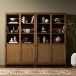 Styled double cabinet placed in room setting with decorative pottery and books