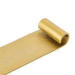 Close-up of curled end highlighting raw brass texture and metallic finish on scroll tray