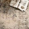 Top-down close-up of Axel Ocean beige rug with a book and dried flowers highlighting detailed abstract pattern