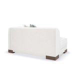 Side view of modular sofa segment featuring rounded armrest and stacked cushion design
