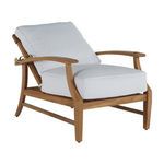 Side profile displaying the reclined angle of the teak chair with white cushions