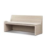 Angled view of vintage white rattan banquette showing curved backrest and cushion depth