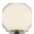 Close-up showing frosted glass globe and brass ring at lamp top