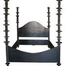 hand-carved black mahogany king bed with curved headboard and posts embellished with variegated mahogany discs