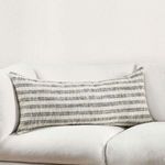 Linna Throw Pillow styled on white sofa showcasing size and modern neutral stripe design