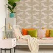 Wallpaper installed in a living room setting with colorful cushions, a plant, and a patterned round rug