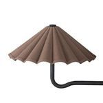 Close-up of a single dark brown scalloped fabric shade and curved black metal arm