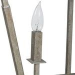 Close-up of one candle-style light with clear bulb atop a rectangular metal holder in antique silver leaf