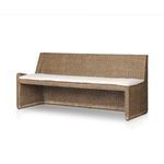 Side angle showing tufted beige cushion surface on woven rattan bench