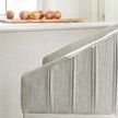 Close-up on side upholstery texture and vertical stitching, showing fabric weave and metal base contrast.
