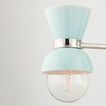 Close-up of one aqua blue shade and clear round bulb with visible filament