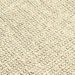 Close-up showing thick boucle texture and handwoven jute fibers in neutral tones