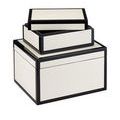 Two boxes stacked with small lid placed off-center exposing inside lining