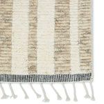 Close-up of ribbed pile texture with fringe and black and white striped edge