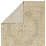 Back side view revealing tightly woven cream backing of the handknotted rug with folded corner