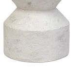 Close-up of bottom section's curved profile and textured off-white concrete finish