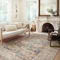 Margot Ocean Spice rug styled in bright living room under sofa and near fireplace with large mirror