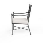 Side profile of Provence Dining Chair highlighting bowed armrest and cushioned seat