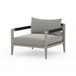 Right angle view of chair showing consistent weathered grey teak and dark wrap details