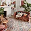 Malik Rose Multi Rug styled in a bohemian living room with terracotta sofa and plants