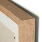 Close-up of natural wood frame corner with visible grain and mitered edge