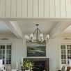 Katie Large Chandelier hanging over living room table with floral centerpiece and artwork on wall