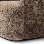 Detailed close-up of tightly curled shearling texture on chair arm