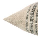 Close-up angled view highlighting soft woven wool texture and gray striped pattern on pillow corner